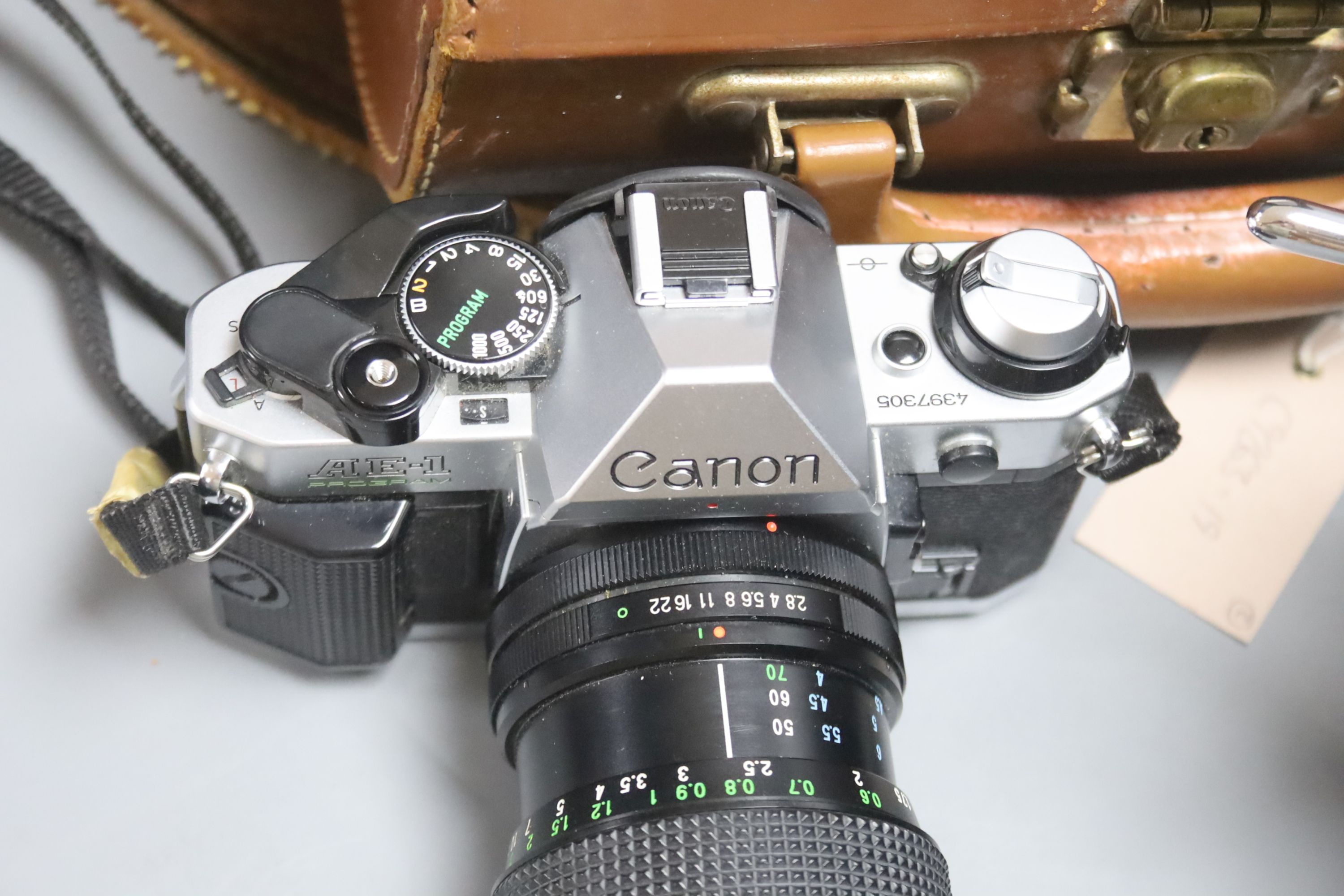 A Canon AE-1 camera serial number 4397305 with a Vivitar macro focusing lens, together with a Paillard Rolex camera